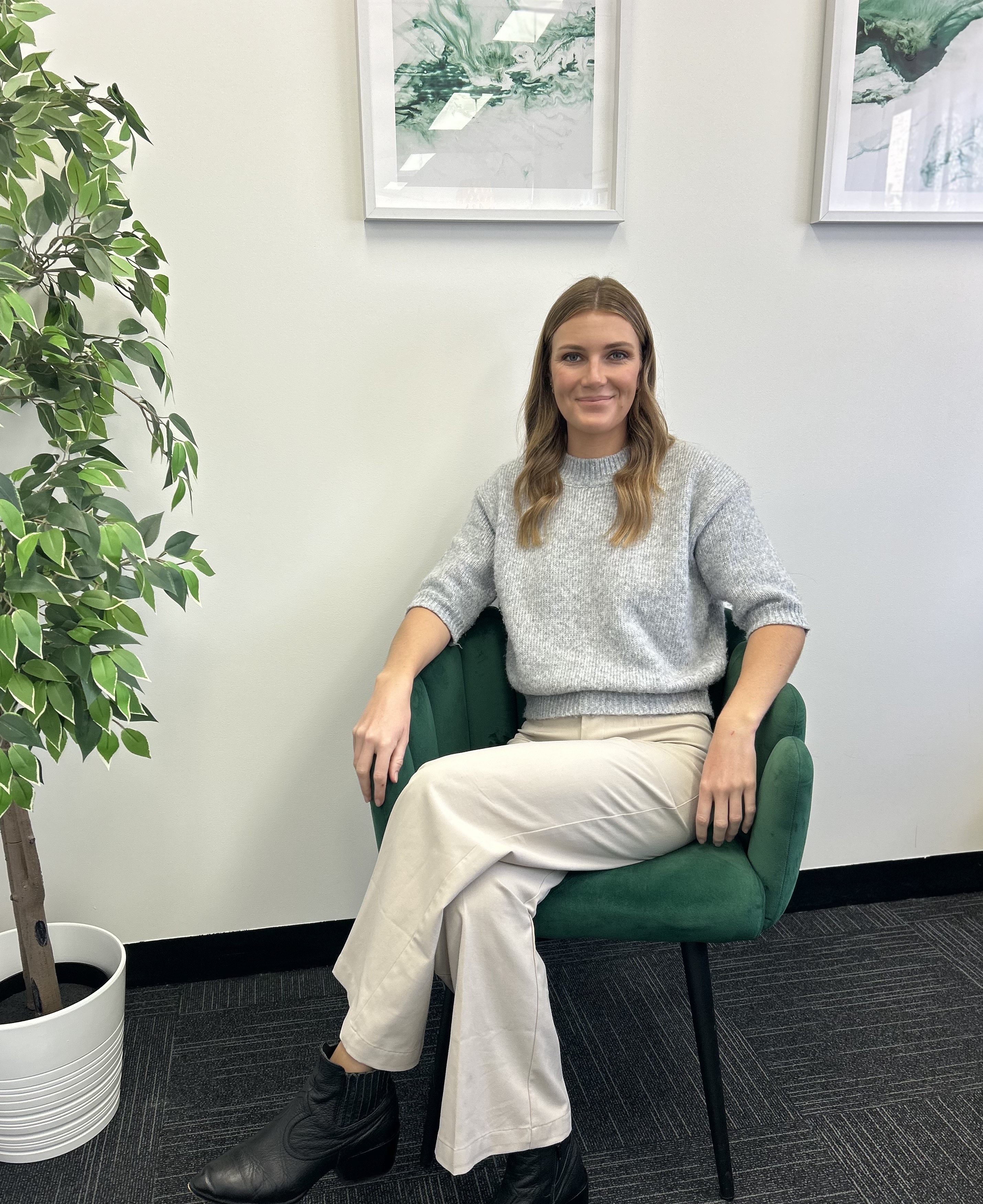 A woman sitting in a chair in an office