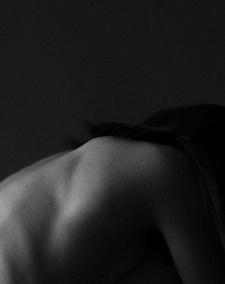 An abstract black and white photo of a womans back